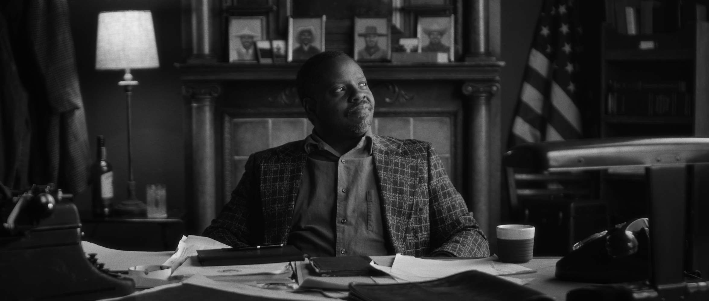 A man sits at a desk.